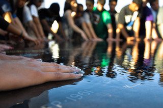 People with their hands in a puddle of water