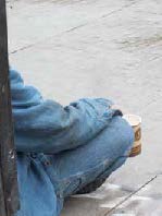 homeless sitting on the sidewalk